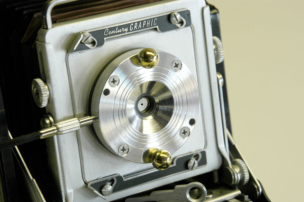 Christiansen's Apo II shutter is made from titanium, brass, and Garolite, and is cable-release activated. Pinholes and zoneplates of varying dimension may be swapped in and out depending on focal length. Christiansen's Apo II shutter is made from titanium, brass, and Garolite, and is cable-release activated. Pinholes and zoneplates of varying dimension may be swapped in and out depending on focal length.